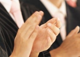 people in business attire clapping