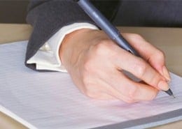 person writing a letter
